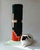 Green with white crosses and a red design along the bottom cat scratcher with a white cat sitting at the base