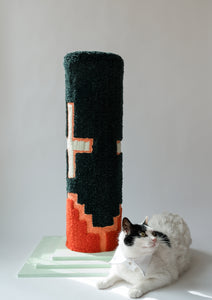 Green with white crosses and a red design along the bottom cat scratcher with a white cat sitting at the base
